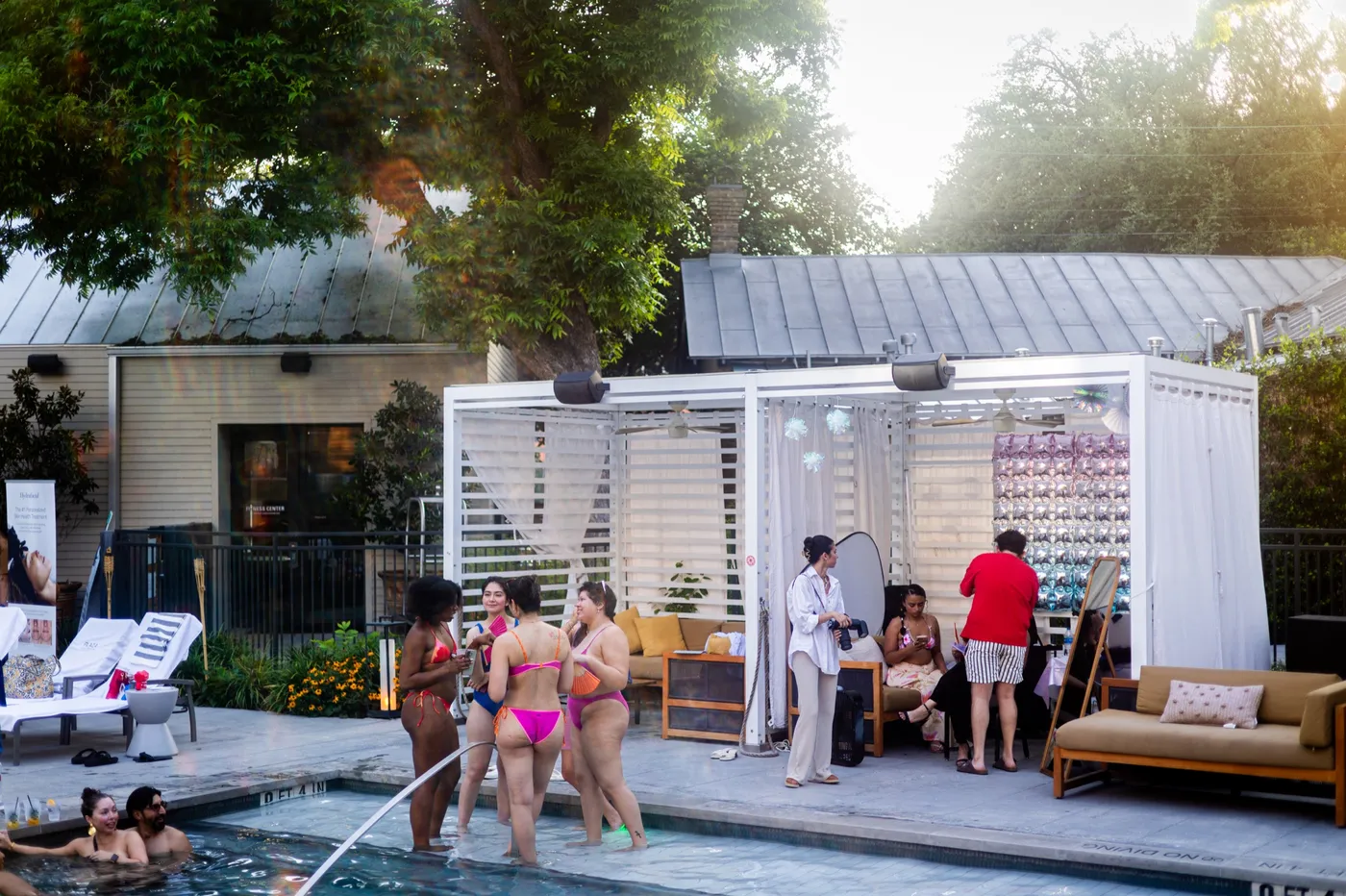 Anaqua Villa Nights live activation — poolside cabanas and guests at golden hour