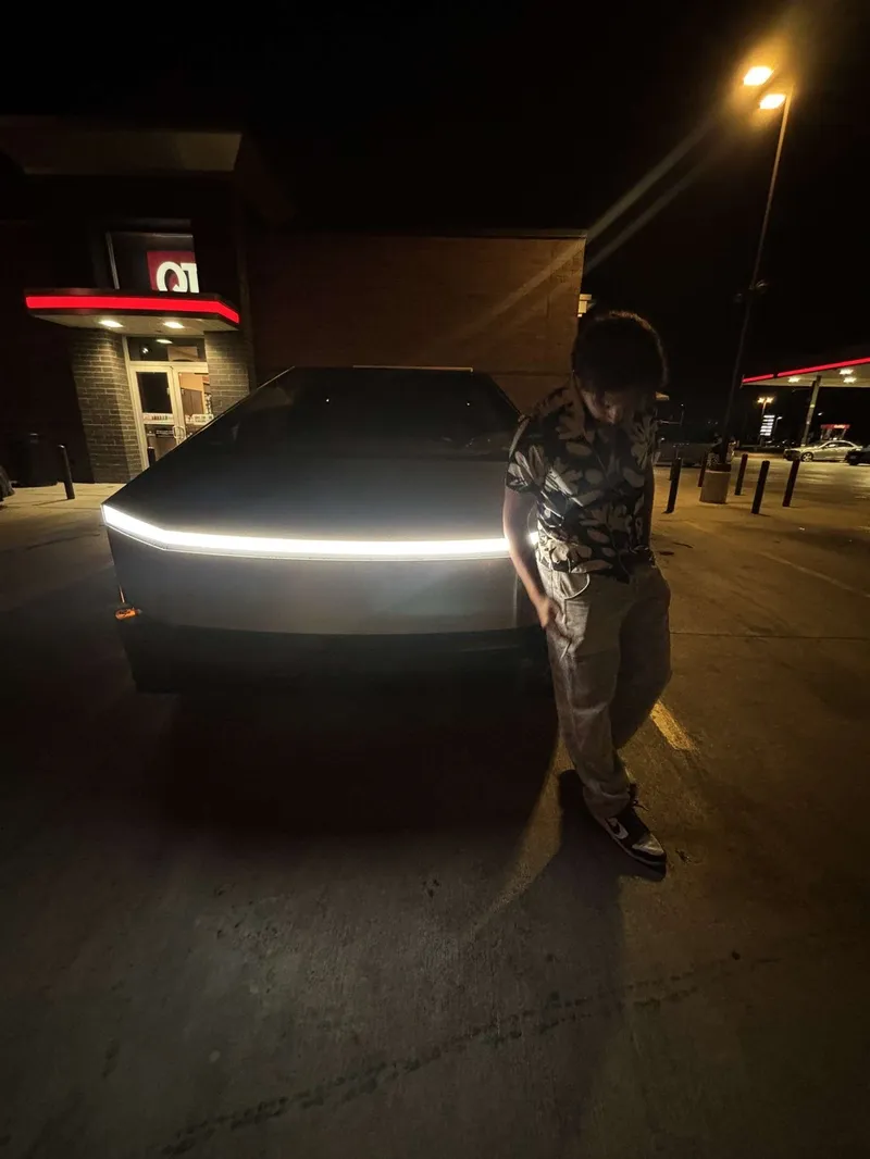 DJ Huevo posed against a Cybertruck at night, photographed by BTA